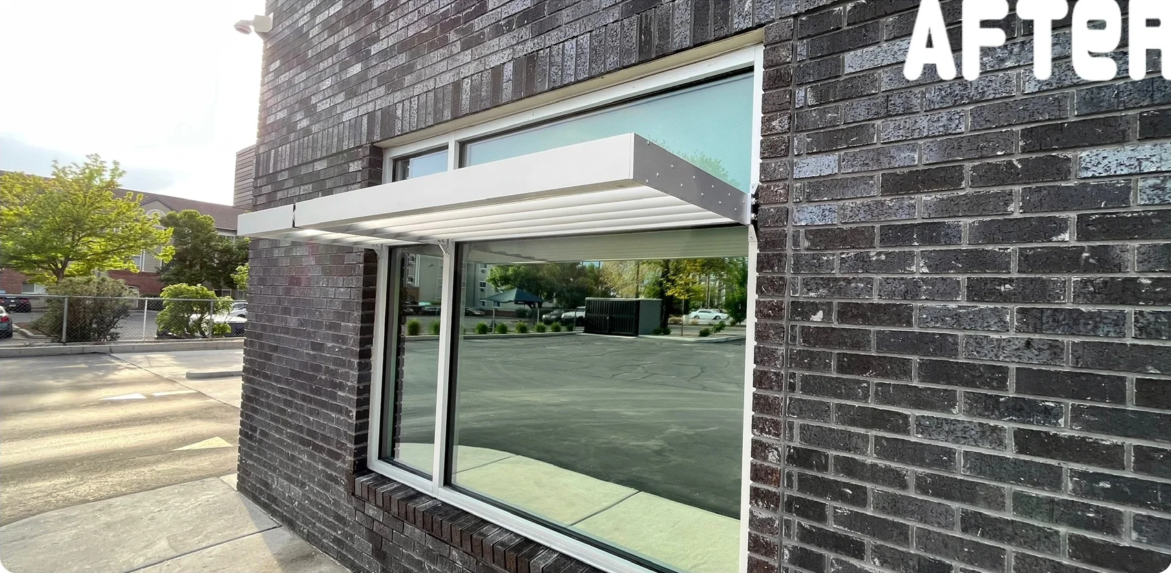 Large window beneath a white awning after cleaning