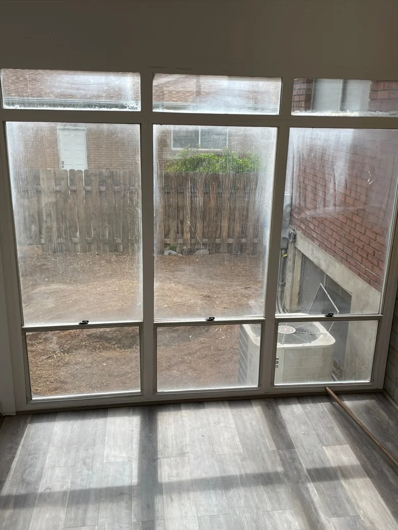 Sunroom windows viewed from inside before cleaning