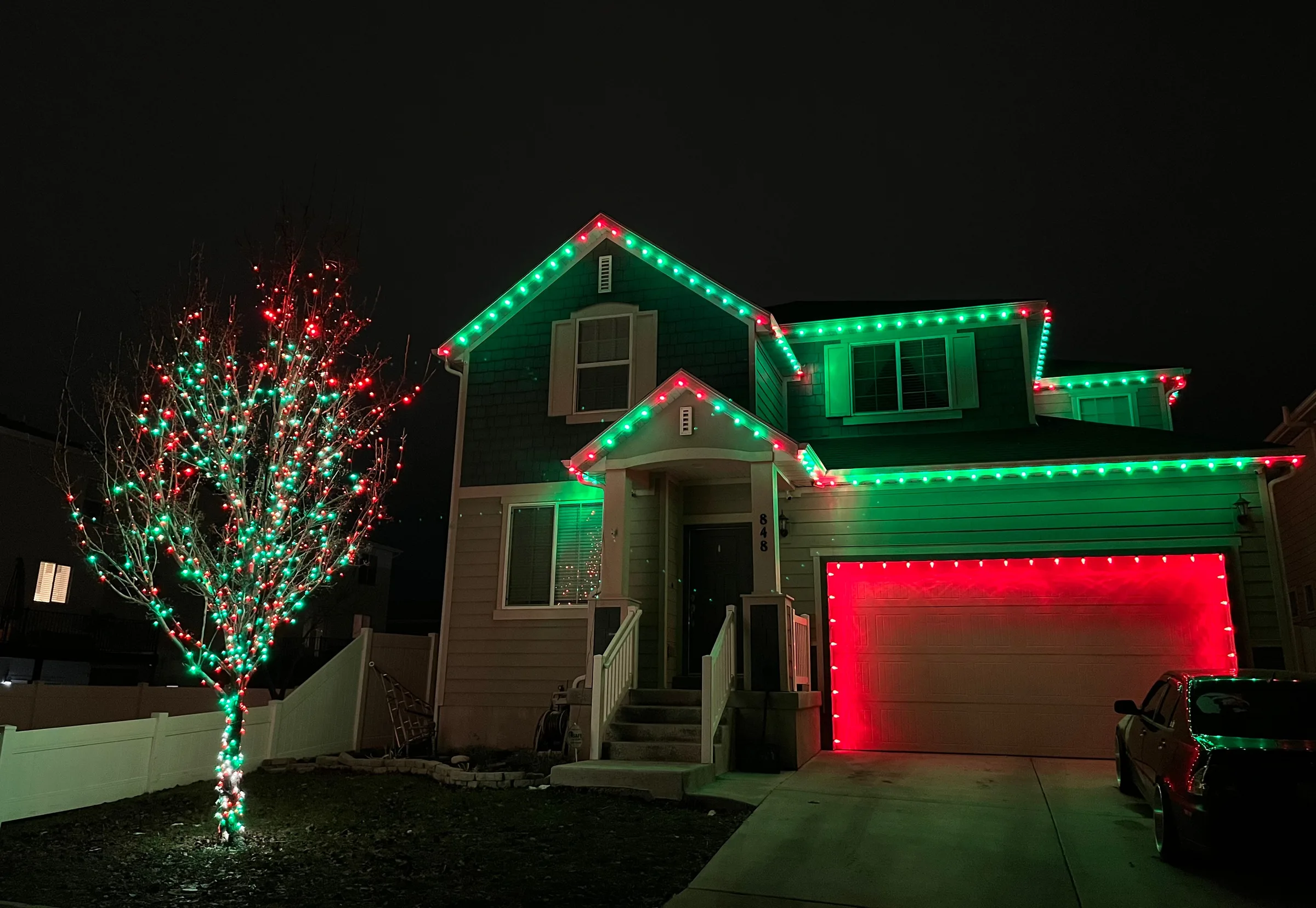 Green rooflines, red garage trim and a wrapped tree