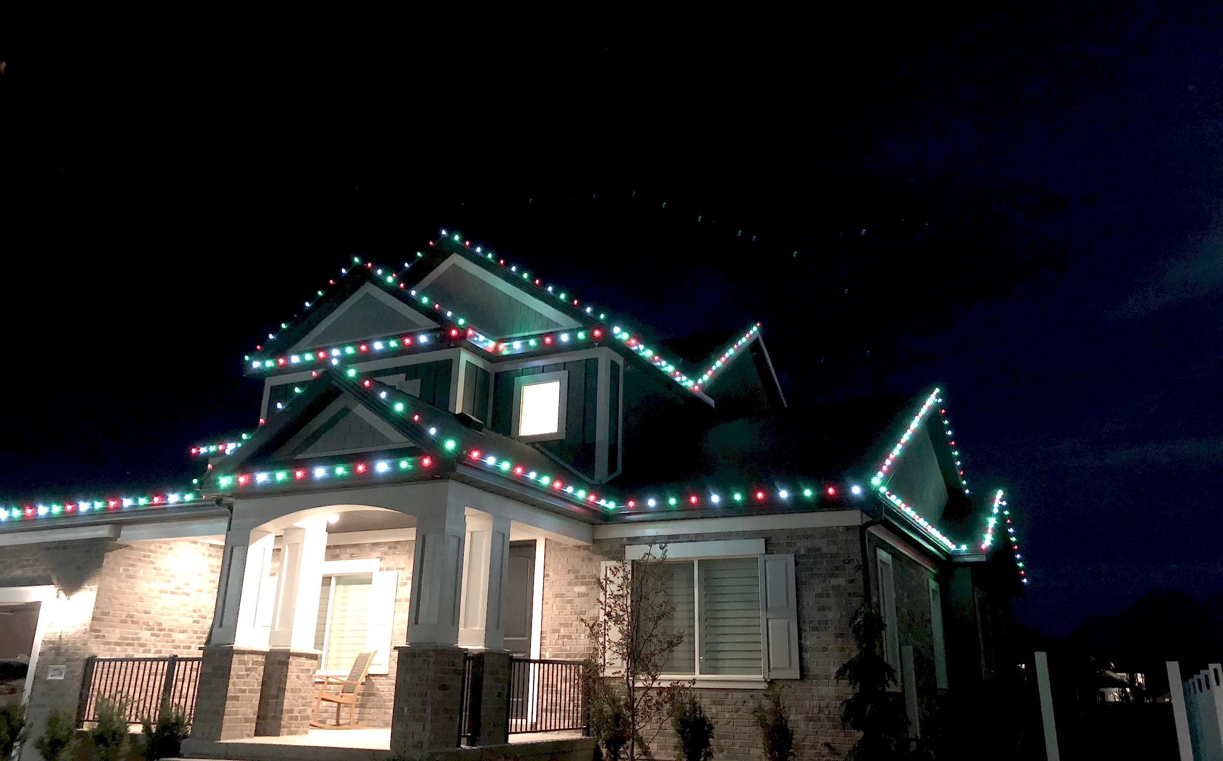 Two-story home with green and white gables