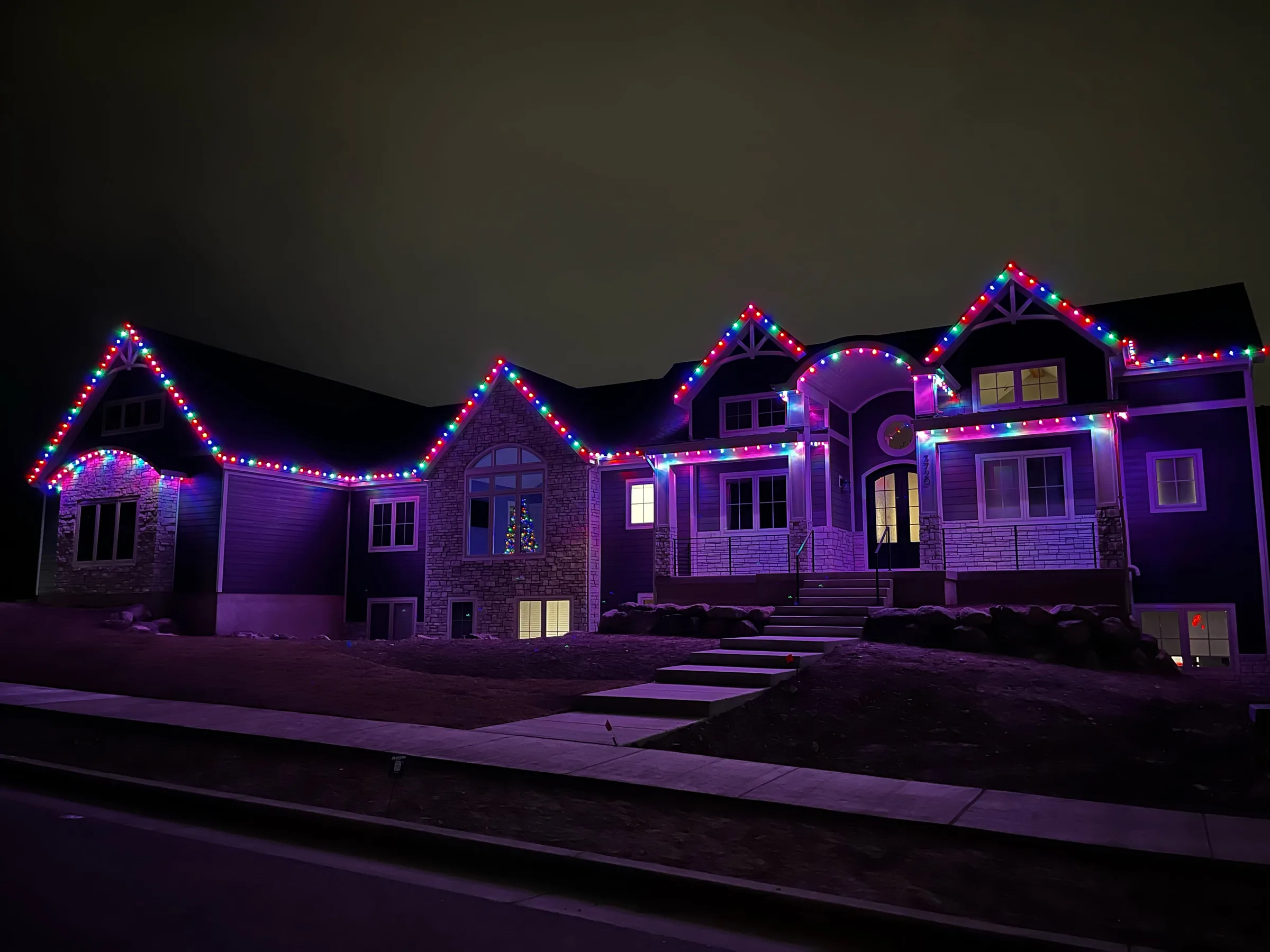 Home outlined in purple and blue lights