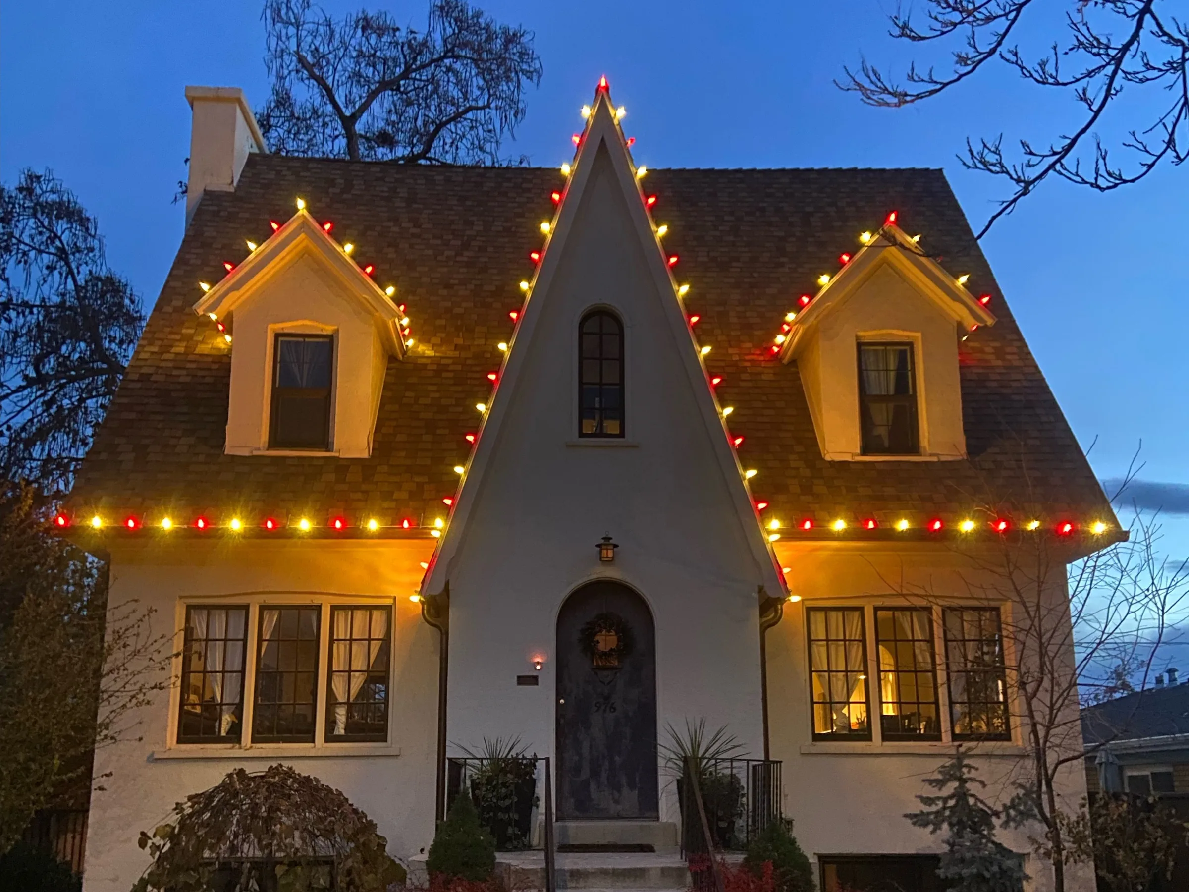 Storybook cottage with a steep gable in red and warm white