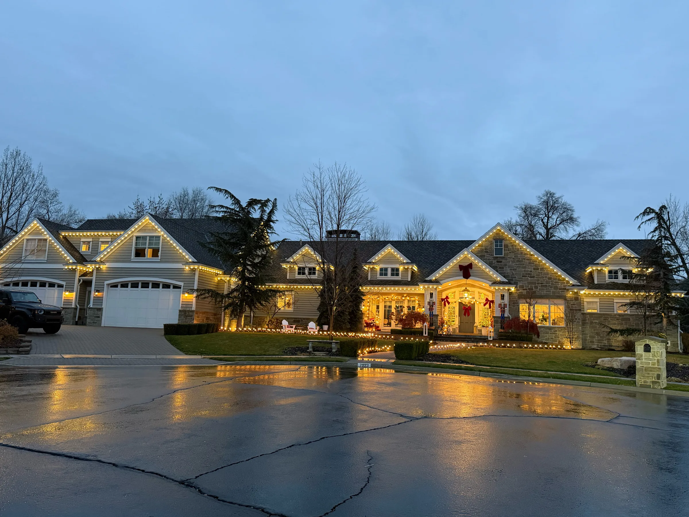 Neighbouring homes lit for the season at dusk